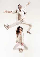 Foto op Plexiglas anti-reflex Talented couple dancing in a bright studio © konradbak