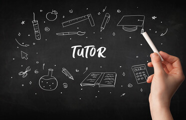 Hand drawing TUTOR inscription with white chalk on blackboard, education concept