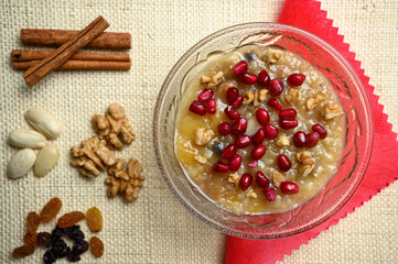 Ashure or Noah's pudding, the turkish dessert porridge in glass bowl on natural matting