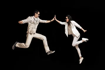 Foto op Plexiglas anti-reflex Talented couple dancing on the black background © konradbak