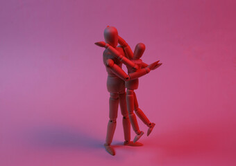 Two puppets hugging in red neon light