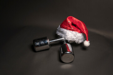 Dumbbells fitness santa claus on black background