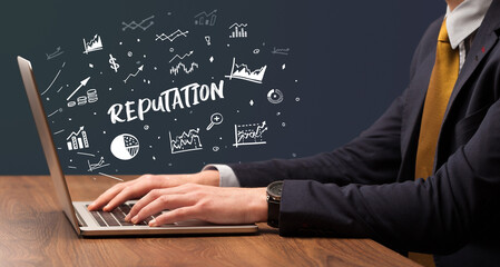 Businessman working on laptop with REPUTATION inscription, modern business concept
