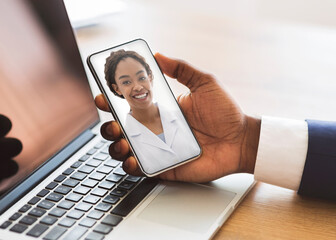 Online Medical Consultancy. Unrecognizable Black Businessman Having Video Call With Therapist Lady