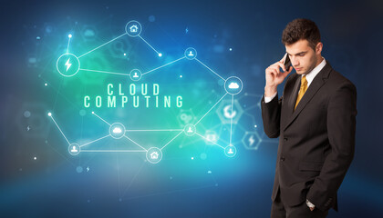 Businessman in front of cloud service icons with CLOUD COMPUTING inscription, modern technology concept