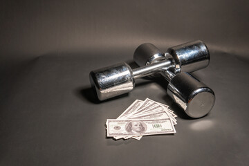 Dumbbells bodybuilding lie, money dollars glitter on a black background silver color