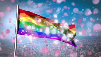 Animation of rainbow flag with white and pink flickering spots over blue sky and cityscape - Powered by Adobe