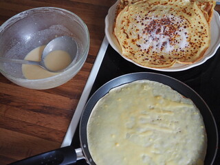 Cooking crepes in frying pan for Candlemas
