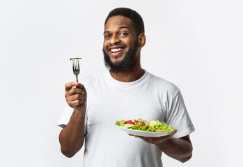 Smiling African American Guy Posing With Vegetable Salad, White Background