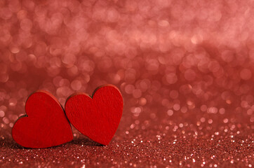 Red wooden hearts on a shiny surface