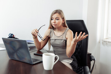 Online call. Business lady communicates emotionally by video call while looking at laptop in her home office