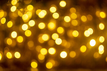Bokeh with gold colors, Festive lights background. Abstract colorful defocused lights. Soft focus