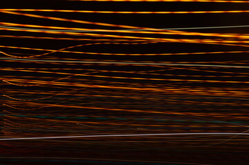 Luminous streamer - neon bright lines on black background.