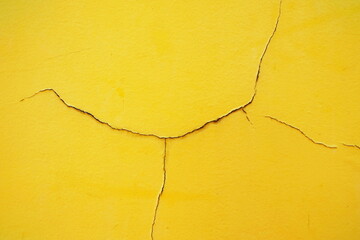 Crack on Yellow Paint Concrete Wall Background.
