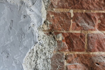 Grey concrete surface with red brick masonry. Composite abstract background with space to copy. close-up