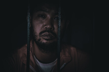 Asian man desperate at the iron prison,prisoner concept,thailand people,Hope to be free,Serious...