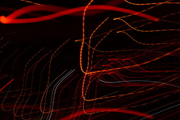 Luminous streamer - neon bright lines on black background.