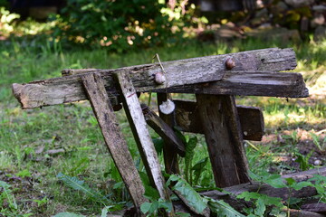 An old sawhorse with snails on it