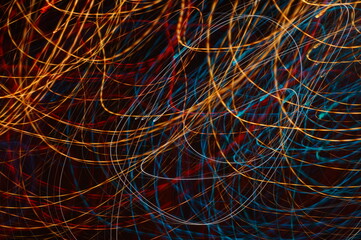 Luminous streamer - neon bright lines on black background.