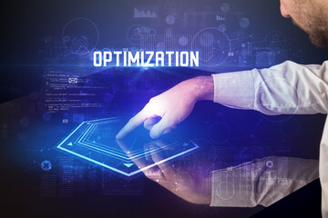 Hand touching digital table with OPTIMIZATION inscription, new age security concept
