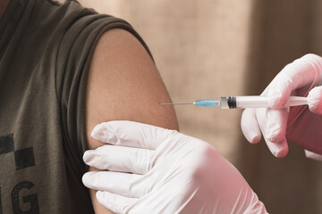 The nurse holding the syringe to give the patient the injection. Covid-19 or coronavirus vaccine
