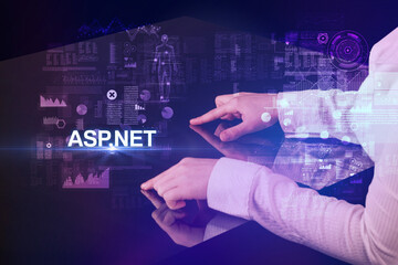 Businessman touching huge display with ASP.NET inscription, modern technology concept