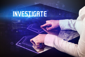 Hand touching digital table with INVESTIGATE inscription, new age security concept