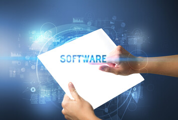 Hand holdig futuristic tablet with SOFTWARE inscription, new technology concept