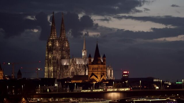 Cologne skyline with cologne cathedral and Gro&szlig; St. Martin. Zoo-Bridge in the foreground with two KVB trains driving on it from the right to left.