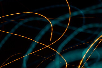 Luminous streamer - neon bright lines on black background.