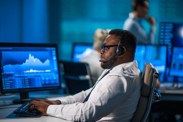 Team of brokers is working in office using workstation and analysis technology. Workplace of...