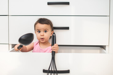 child in a drawer with the polish in his hand having fun