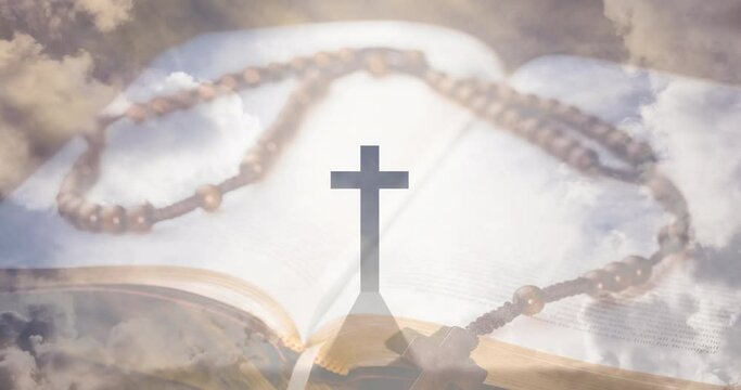 Animation of christian cross, rosary and holy bible over clouds