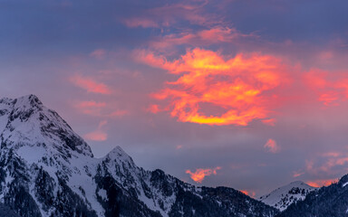 Clouds appear painted with bright red and orange in beautiful winter sunset
