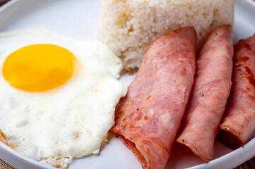 Hamsilog (close up no cutlery)- famous Filipino meal that consists of fried rice, egg and ham slices.

