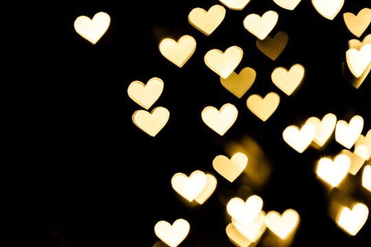 Festive overlay effect. Blurred golden heart bokeh festive glitter background. Christmas, New Year and Valentine's day design