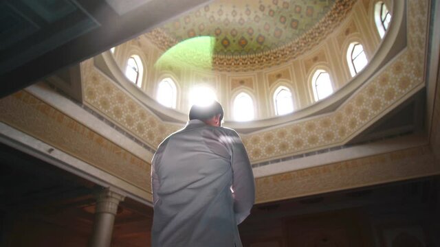 Religious muslim man praying inside the mosque