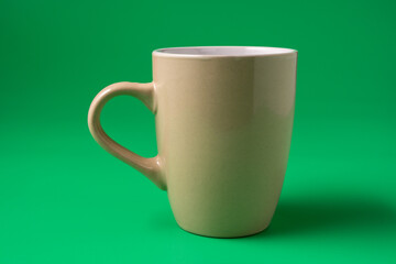 Big mug on green background, front view.