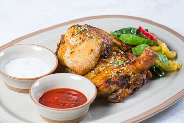 Roasted chicken leg quarters with crispy golden brown skin.