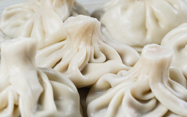 Georgian dumplings Khinkali with meat on white plate.