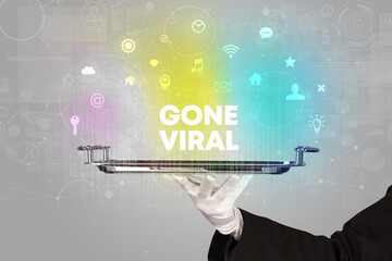 Waiter serving social networking with GONE VIRAL inscription, new media concept