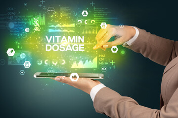 Close-up of a touchscreen with VITAMIN DOSAGE inscription, medical concept