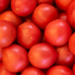 Red fresh tomatoes close-up, background, texture.