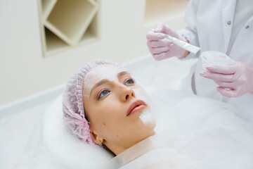 A young girl in a cosmetology office is undergoing facial skin rejuvenation procedures. Cosmetology.