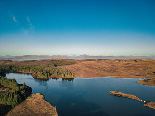 Fototapeta na wymiar Loch Lomond and the Trossachs National Park which lurks in the distant morning haze - Drone photography - Scotland