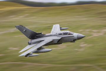 RAF Tornado strike fighter flying low level in the mountains of the UK. 