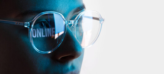 Close up view of blue eye in glasses with futuristic holographic interface to display data....