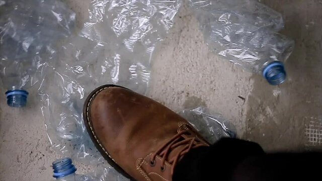 man crushing empty recycle plastic bottles before recycling stock video stock footage