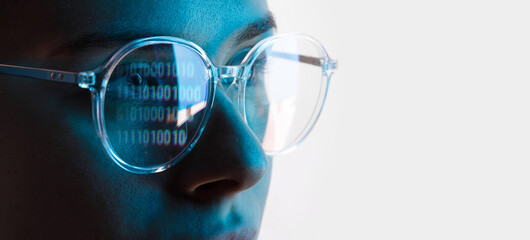 Close up view of blue eye in glasses with futuristic holographic interface to display data....