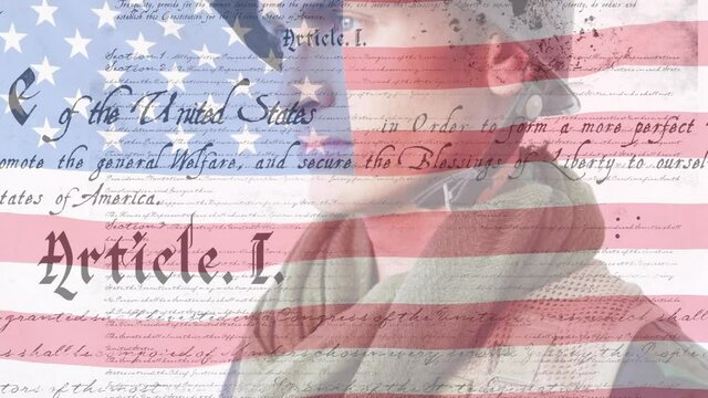 Digital composite video of us constitution text against waving us flag and american soldier